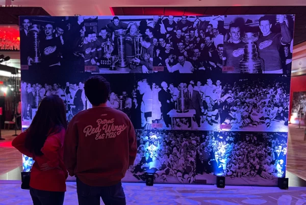fans looking a mural