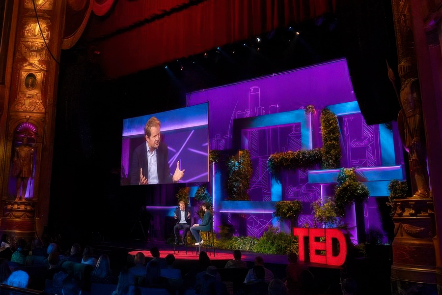 TedX_Countdown_Detroit_04 Two speakers on stage, with video wall and floral design