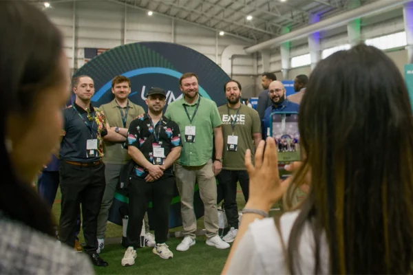 Attendees take photos in front of photo opp